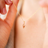 Pure Heart Necklace displayed on a model's neck, featuring a delicate gold heart pendant.