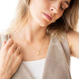 Pure Heart Necklace displayed on a model, featuring a delicate heart pendant and a chain length of 45 cm.