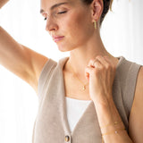 Model wearing the Pure Heart Necklace with gold accents, showcasing a delicate design and modern style.