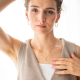 Model showcasing Pure Heart Necklace, 14kt gold, 45 cm length, worn elegantly with subtle accessories.
